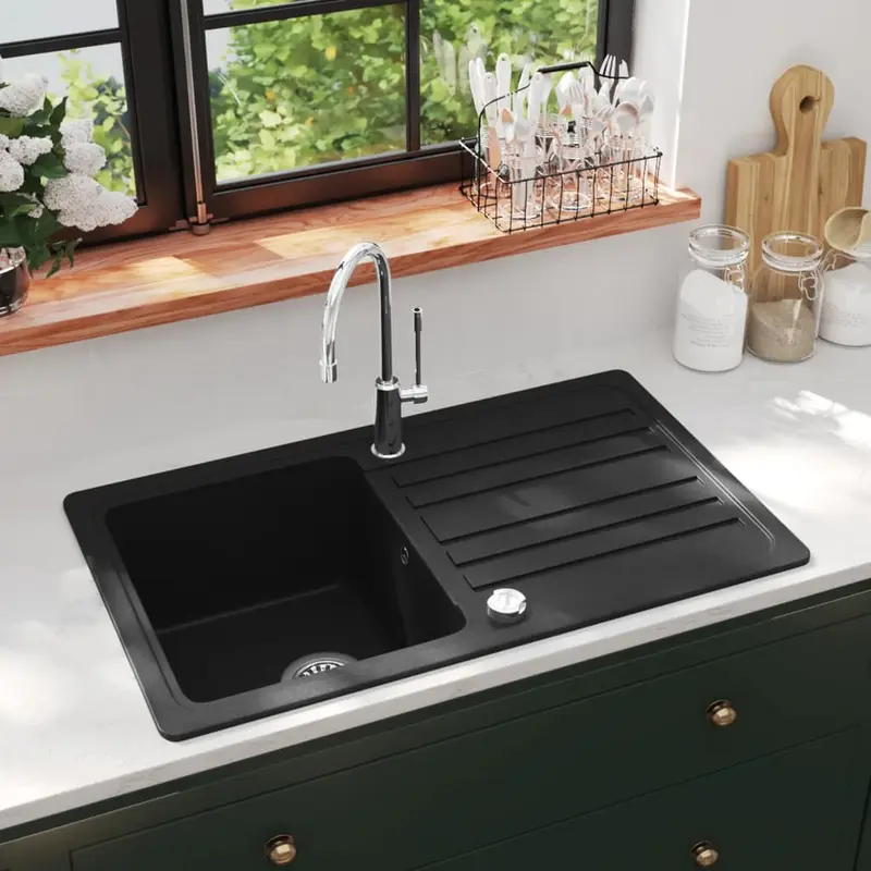 Fregadero de cocina de granito con un seno y escurridor negro